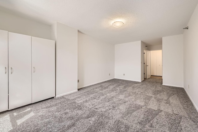 401 1st St Unit 414, Minneapolis, MN 55401 - unfurnished bedroom featuring carpet floors, a textured ceiling, and baseboards