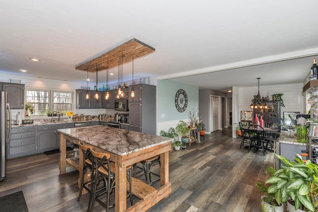 interior space with recessed lighting, a notable chandelier, and dark wood finished floors