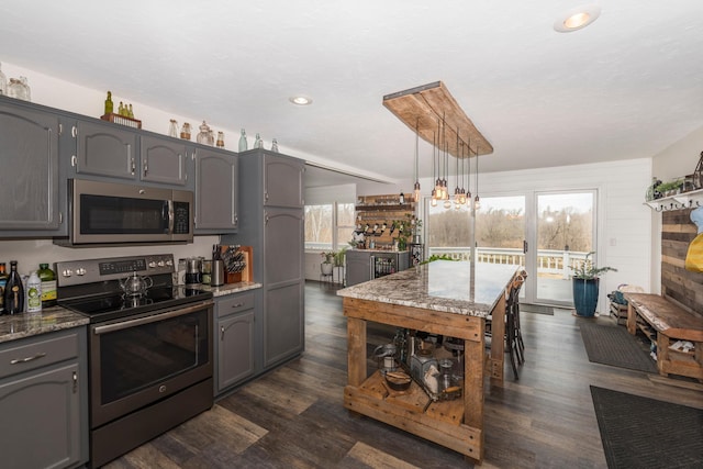 kitchen featuring recessed lighting, gray cabinets, appliances with stainless steel finishes, and light stone countertops