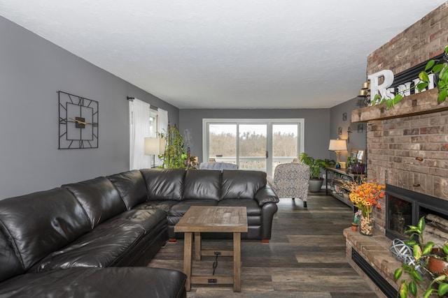 living area featuring a brick fireplace and wood finished floors