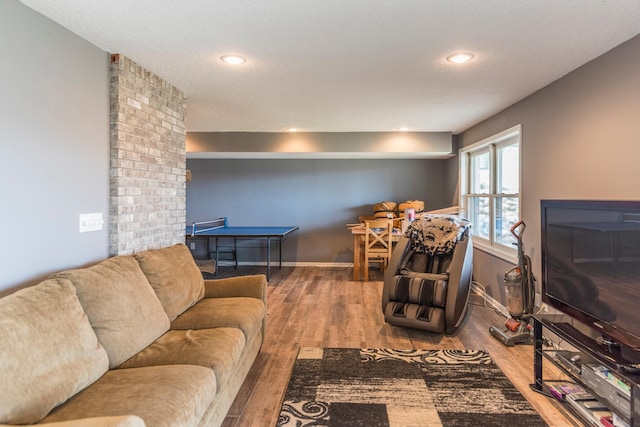 living area featuring recessed lighting, baseboards, and wood finished floors