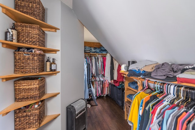 walk in closet featuring heating unit and dark wood-style flooring