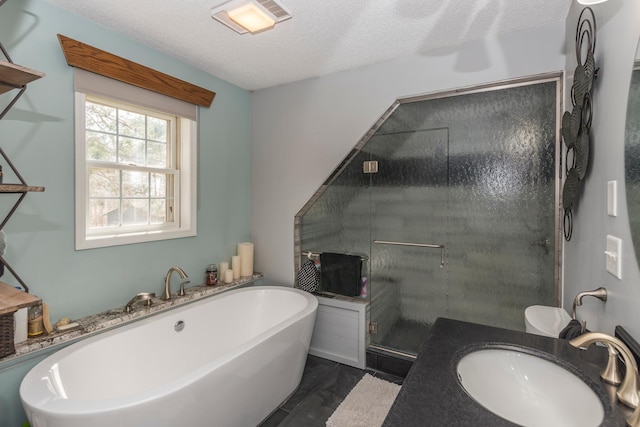 full bath featuring a sink, a soaking tub, a stall shower, and a textured ceiling