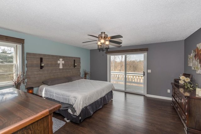 bedroom featuring a textured ceiling, dark wood finished floors, multiple windows, and access to exterior
