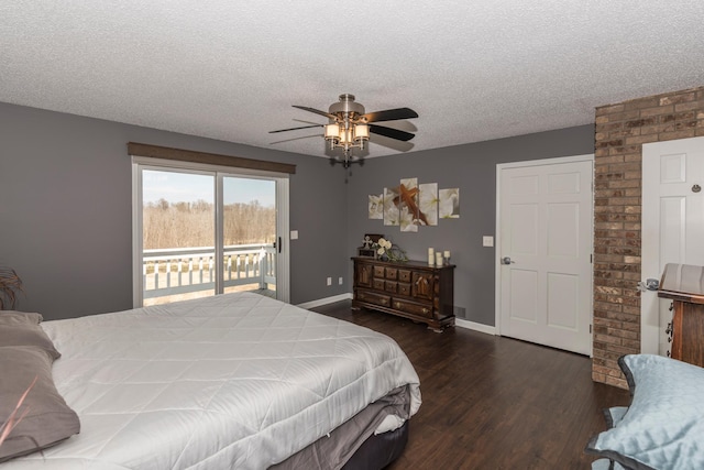 bedroom with access to outside, a textured ceiling, dark wood-style flooring, and baseboards
