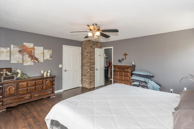 bedroom featuring baseboards, dark wood finished floors, and ceiling fan