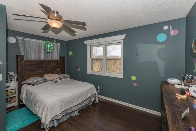 bedroom with visible vents, wood finished floors, baseboards, a textured ceiling, and a ceiling fan