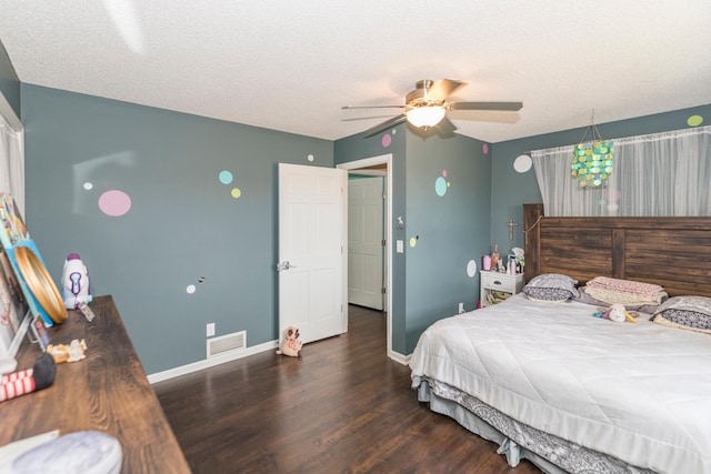 bedroom featuring baseboards, a ceiling fan, wood finished floors, and visible vents
