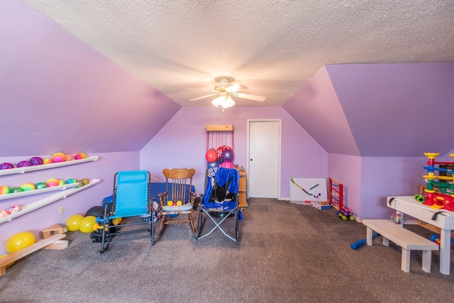 recreation room featuring carpet floors, a ceiling fan, a textured ceiling, and lofted ceiling