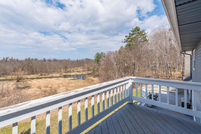 wooden terrace featuring a water view
