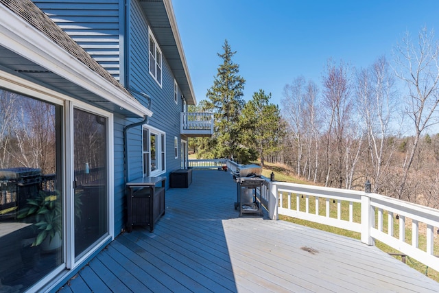wooden deck featuring a grill