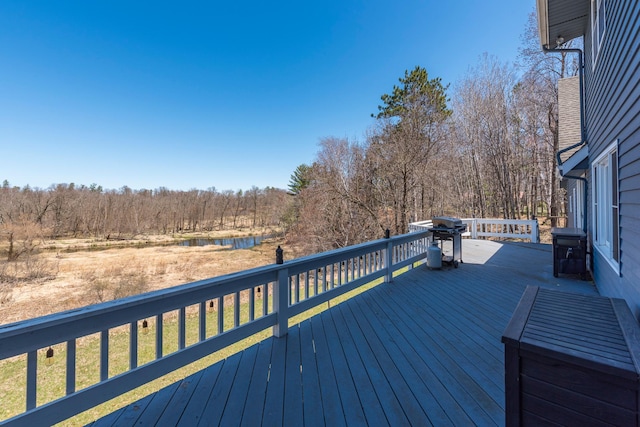 wooden deck featuring a water view and area for grilling