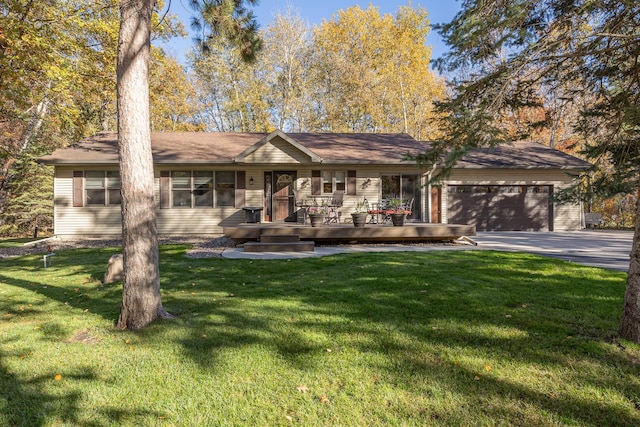 single story home featuring a garage, a front lawn, and aphalt driveway