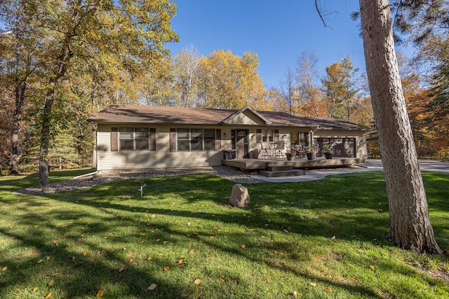 rear view of property with a yard and a deck