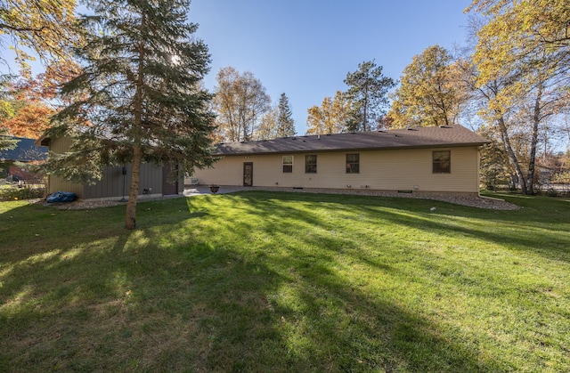 rear view of house with a yard