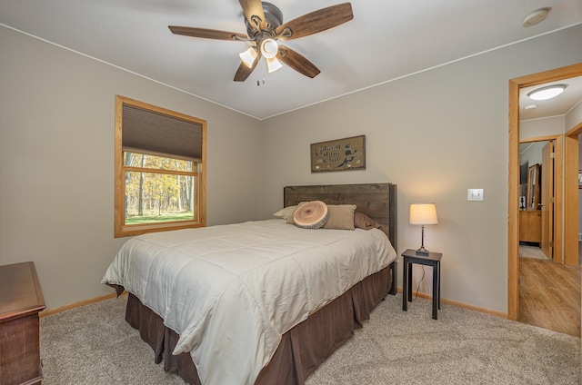 bedroom featuring baseboards, ceiling fan, and carpet flooring