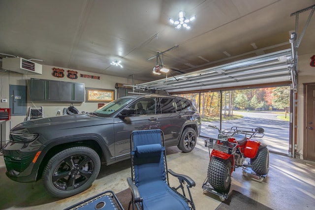 garage with a garage door opener and electric panel