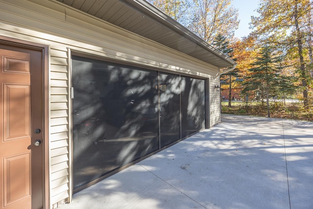 garage with concrete driveway
