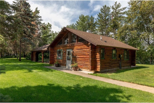 back of property featuring a yard, a patio, and log exterior