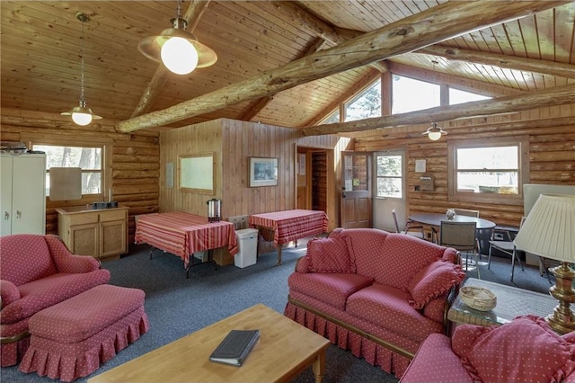 carpeted living area with plenty of natural light, rustic walls, wooden ceiling, and high vaulted ceiling