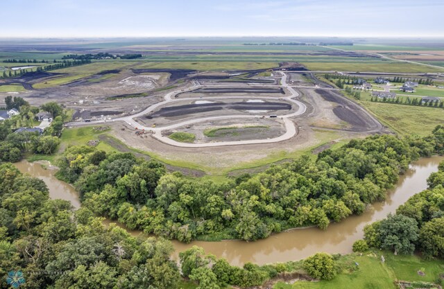 drone / aerial view featuring a water view and a rural view