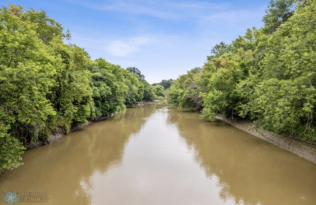 water view featuring a forest view