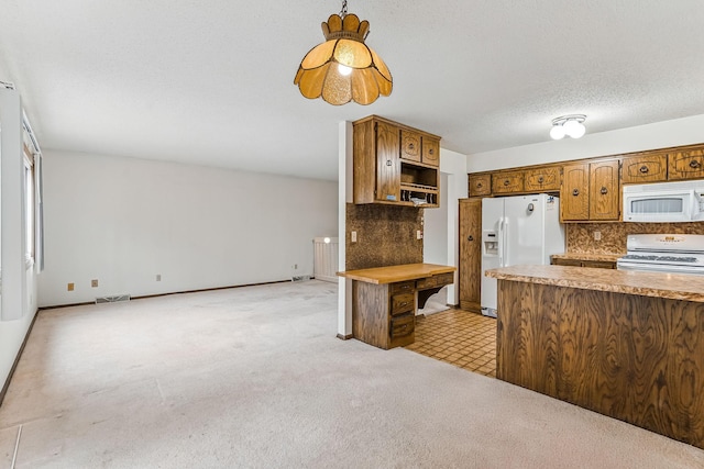 kitchen with light colored carpet, white appliances, light countertops, tasteful backsplash, and visible vents