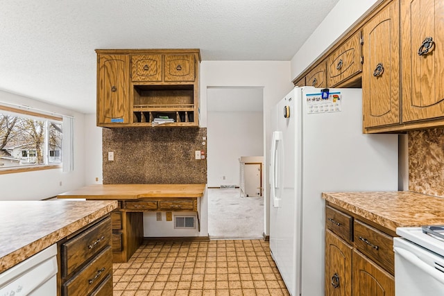 kitchen with light floors, light countertops, decorative backsplash, and visible vents