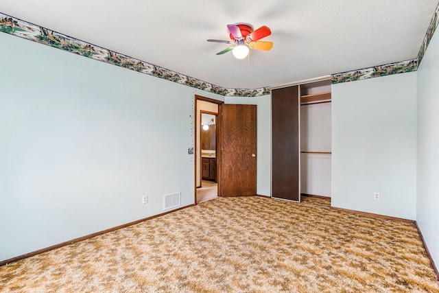 unfurnished bedroom featuring baseboards, ceiling fan, carpet flooring, and visible vents