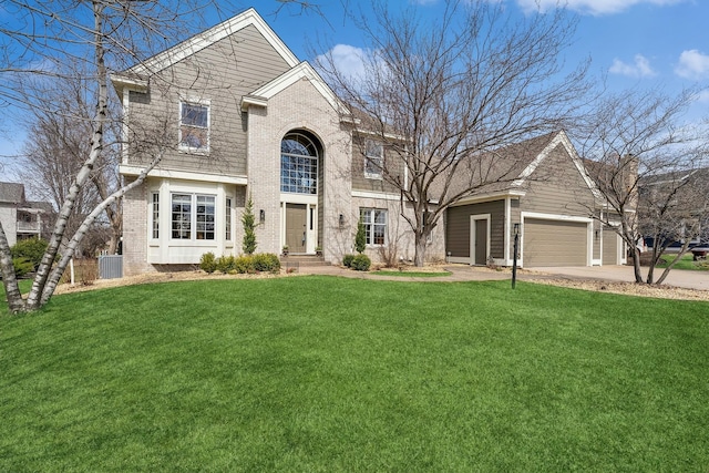 3412 Williamsburg Pkwy, Woodbury, MN 55129 - view of front of house featuring brick siding, an attached garage, driveway, and a front yard