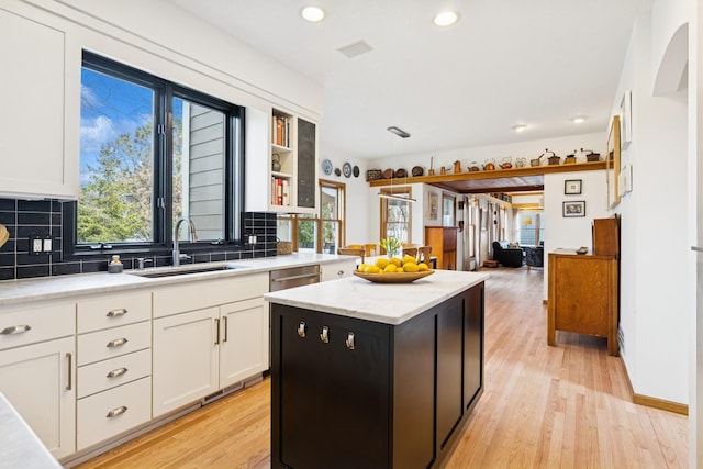 3412 Williamsburg Pkwy, Woodbury, MN 55129 - kitchen with white cabinetry, recessed lighting, a sink, and tasteful backsplash