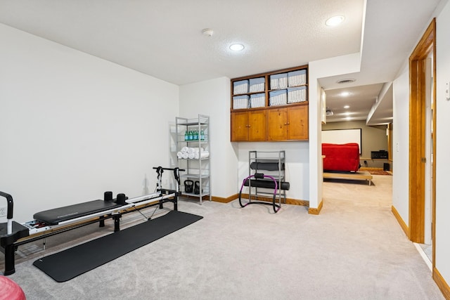 3412 Williamsburg Pkwy, Woodbury, MN 55129 - workout area featuring light colored carpet, a textured ceiling, recessed lighting, baseboards, and visible vents