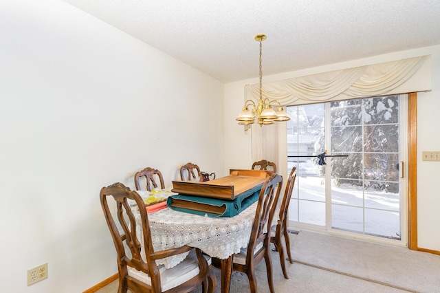 dining area featuring an inviting chandelier and carpet floors