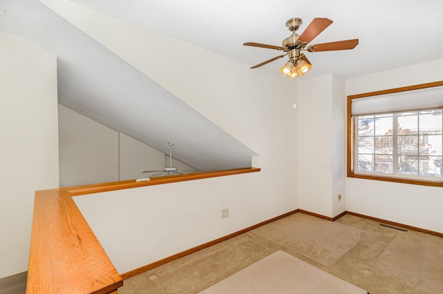 unfurnished room featuring a ceiling fan, baseboards, visible vents, and carpet