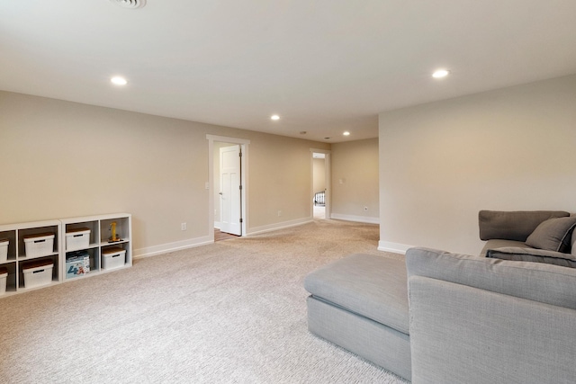 living room with recessed lighting, baseboards, and light carpet