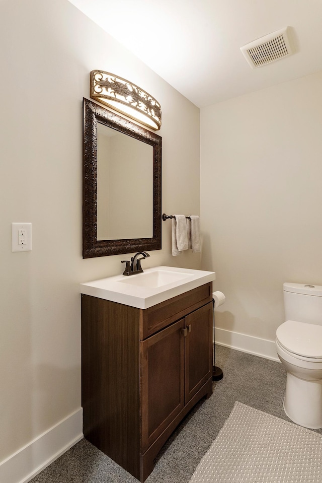 bathroom featuring visible vents, baseboards, toilet, and vanity
