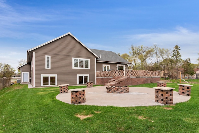 rear view of house featuring a lawn, fence, and a patio area