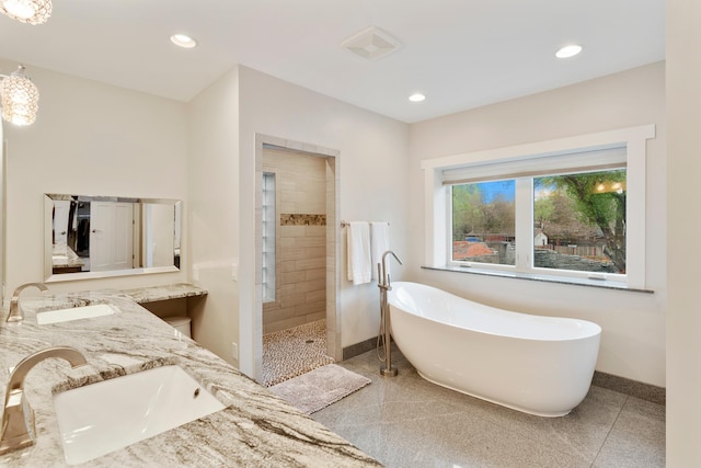 11824 Winnetka Ave N, Champlin, MN 55316 - full bathroom with baseboards, walk in shower, a freestanding tub, and a sink