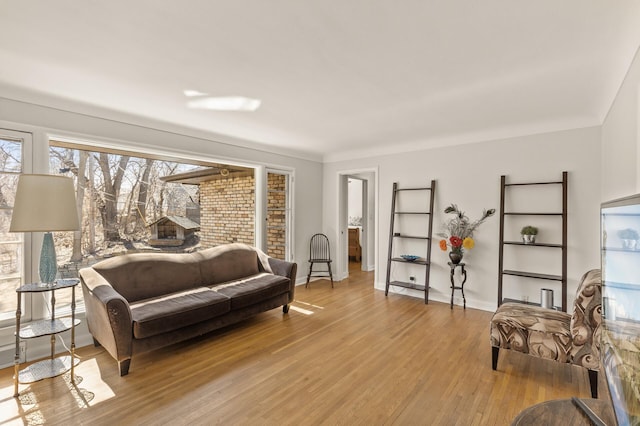living area with baseboards and light wood-type flooring