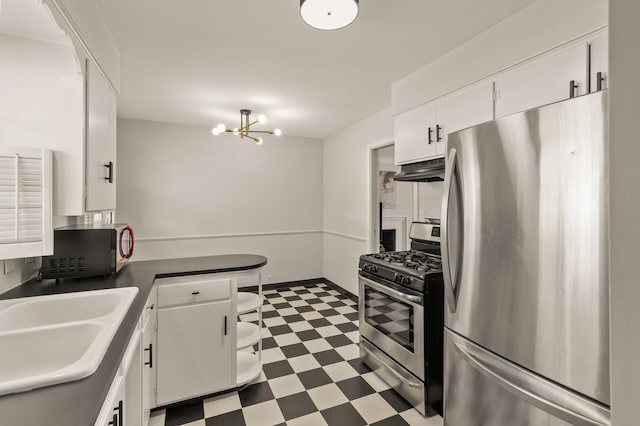 kitchen with tile patterned floors, white cabinets, stainless steel appliances, and under cabinet range hood