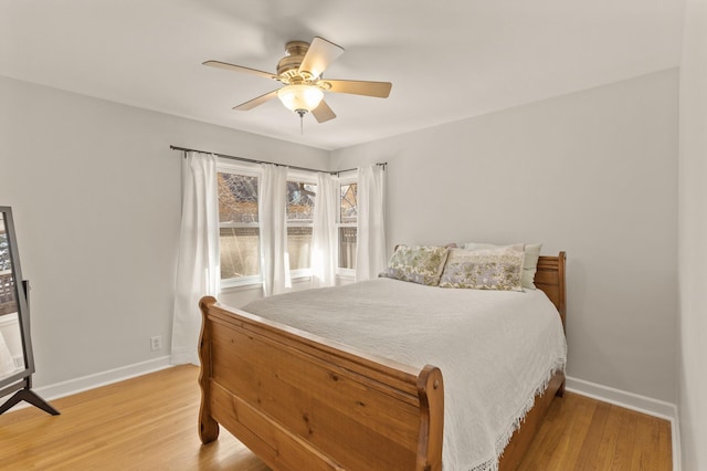bedroom featuring baseboards, a ceiling fan, and light wood-type flooring