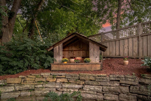 view of outbuilding with fence