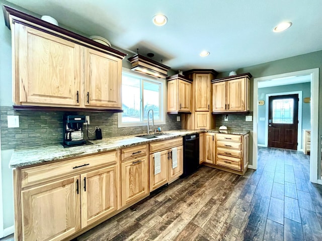 kitchen with light brown cabinetry, dark wood finished floors, a sink, and dishwasher