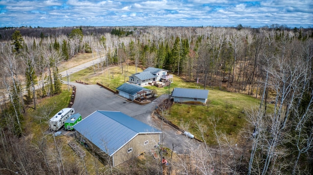 birds eye view of property with a forest view