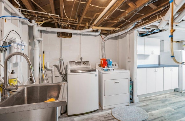 956 10th Ave SE, Forest Lake, MN 55025 - clothes washing area with separate washer and dryer and light wood-style flooring