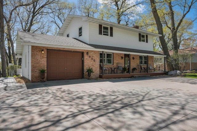 956 10th Ave SE, Forest Lake, MN 55025 - view of front of house with covered porch, an attached garage, driveway, brick siding, and a chimney