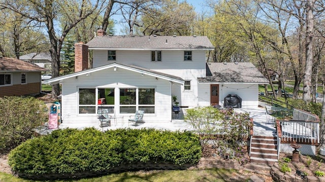 956 10th Ave SE, Forest Lake, MN 55025 - view of front of home featuring a chimney, a wooden deck, and a carport