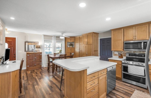 956 10th Ave SE, Forest Lake, MN 55025 - kitchen featuring appliances with stainless steel finishes, ceiling fan, light countertops, dark wood-style flooring, and recessed lighting