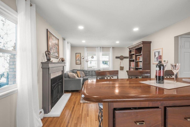 956 10th Ave SE, Forest Lake, MN 55025 - kitchen with light wood-type flooring, a fireplace with raised hearth, and recessed lighting