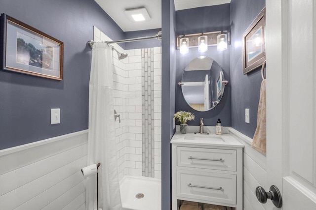 956 10th Ave SE, Forest Lake, MN 55025 - bathroom featuring a stall shower, a wainscoted wall, and vanity